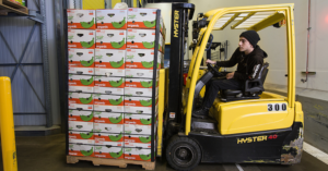 Trask Pernetti, a warehouse trainer with Organically Grown Company, moves a pallet of bananas in a banana ripening room.