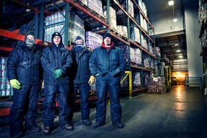 umpqua dairy freezer employees standing in large freezer area wearing thick jumpsuits and hats