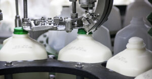 milk gallons being filled in a factory