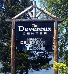 a wooden sign for The Devereux Center