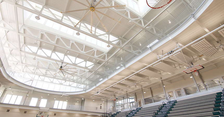 an interior view of a gym with skylights letting in lots of natural light