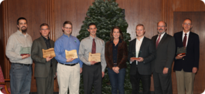 Photo caption (L to R): Spencer Hull, Stimson Lumber; Mark Eitzen, Gunderson LLC; Mike Lane, Norpac Foods / Brooks; Tyler Kuenzi, Elkay Wood Products Company; Oregon First Lady Cylvia Hayes; Kyle Stavig, Myers Container; Bob Repine, Oregon Department of Energy; Walt Meyer, Metropolitan Wastewater Management Commission