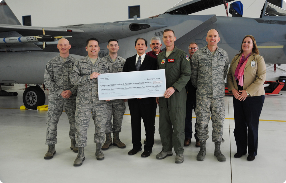 Peter West, director of energy programs for Energy Trust, presented an incentive check to the Oregon Air National Guard for work with Energy Trust for implementing energy-efficient lighting projects throughout the base.