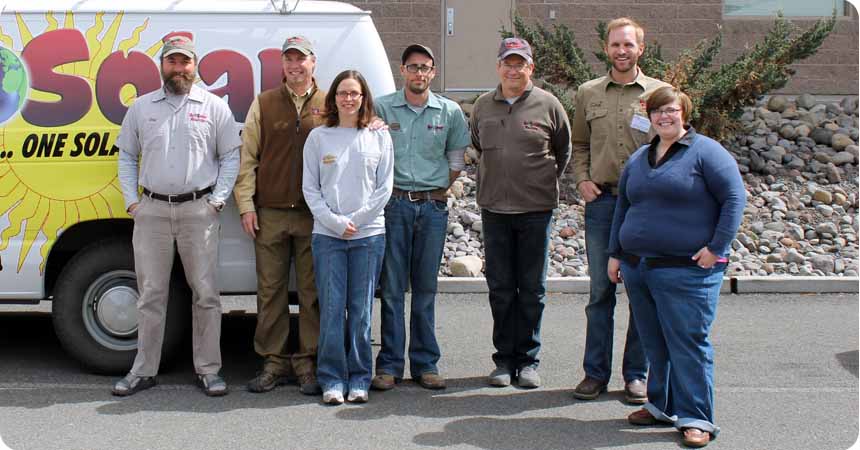 EcoSolar and Electric employees standing in front of their van.