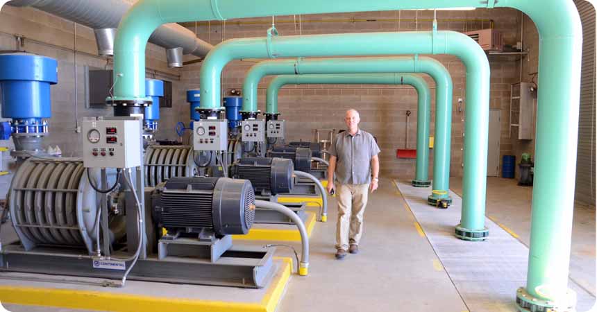 General Manager, Michael T. Fritschi walks through a pump house at the Klamath Falls wastewater treatment plant.