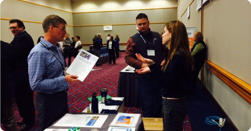woman explaining some materials to a man at a conference