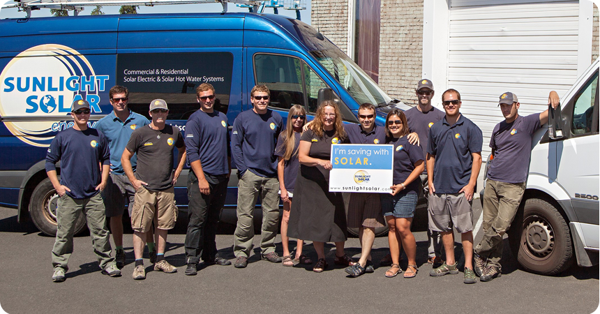 the Sunlight Solar energy team standing in front of a van
