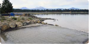 a scenic resevoir with mountains in the background