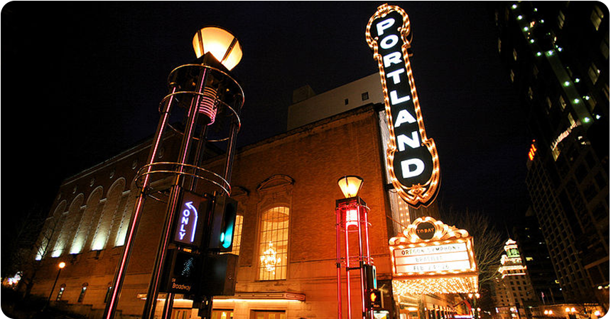 a neon sign reading "Portland"