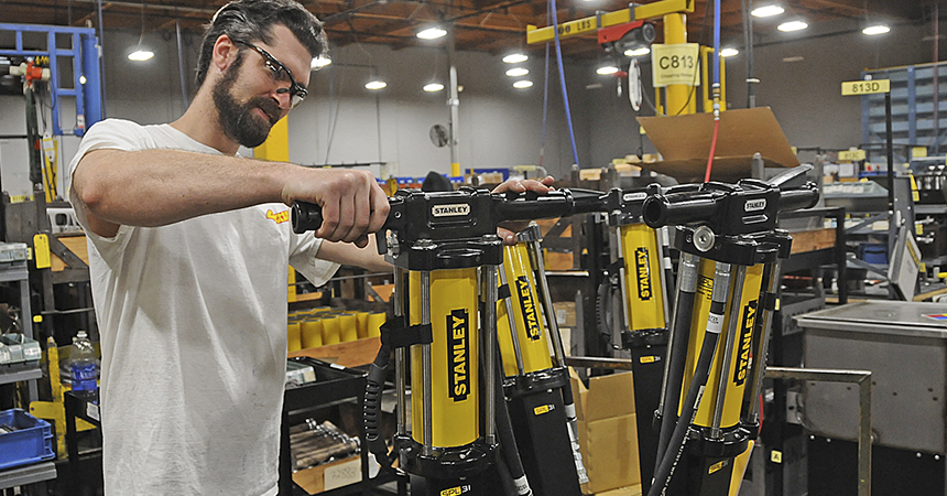 man with safety glasses inspects a stanley product
