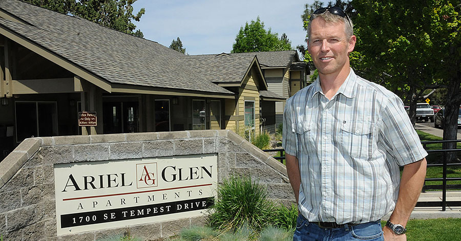 Kieth Wooden stands outside of the Ariel Glen Apartment building