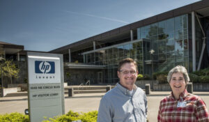 a man and a woman standing in front of the Hewlett Packer building