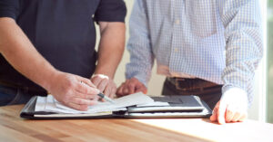 close up shot of two people reviewing paperwork