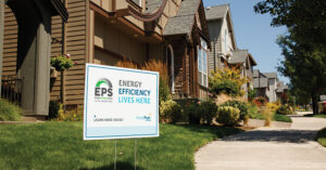a yard sign saying "energy efficiency lives here" in the front yard of a home