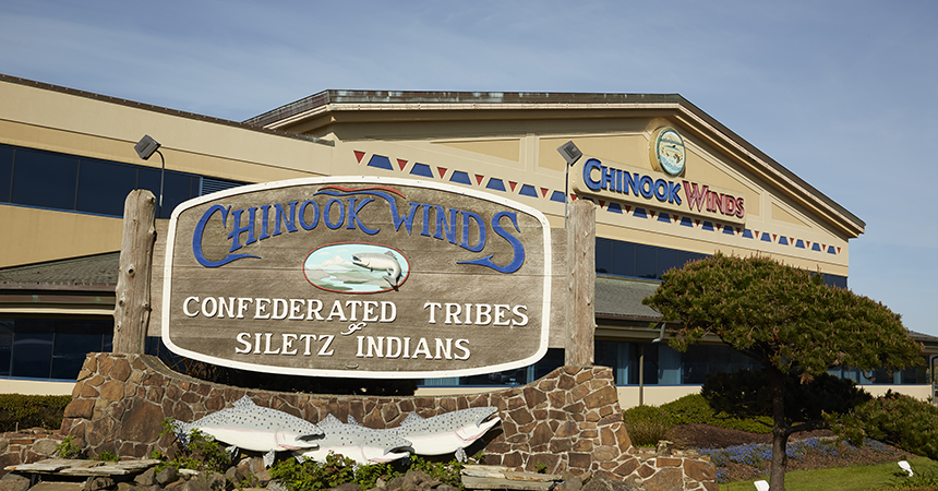 exterior of the Chinook Winds casino with a detailed wooden sign