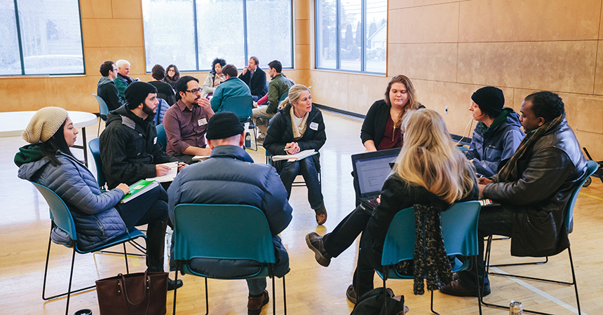 a group of solar workshop attendees in a circle of chairs having a discussions