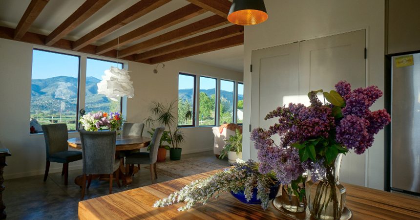 a beautiful home interior with a vase of flowers on a wooden table