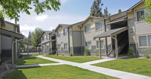 an exterior of an apartment building on a sunny day