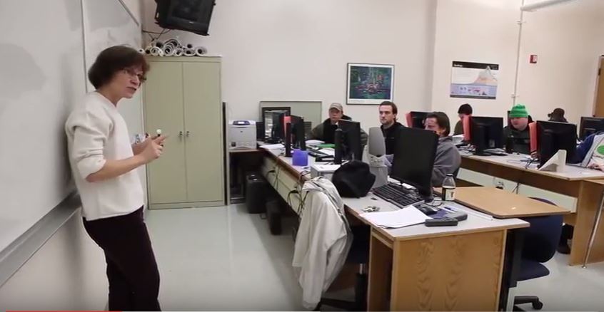 teacher in front of classroom at community college