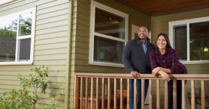 man and woman standing on their home's porch