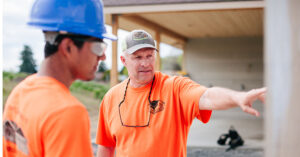 student learning from a construction professional on site