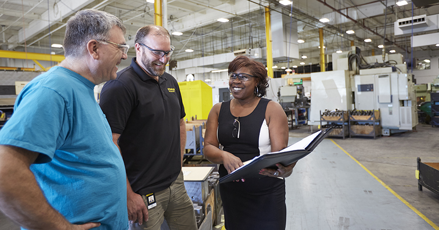 three stanley hydraulics workers smiling