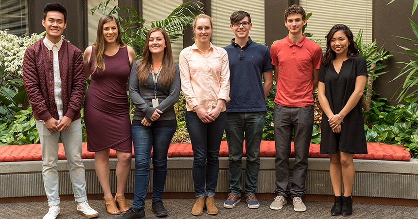 seven of the Energy Trust interns in front of foliage