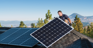 a trade ally installing a solar panel on a home