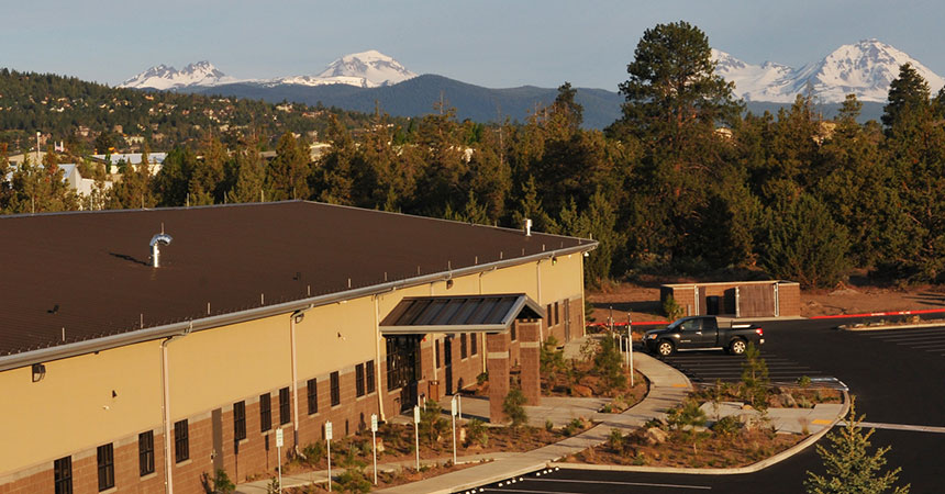 View of the outside of the BendBroadband Data Center with the Three Sisters mountains in the background.