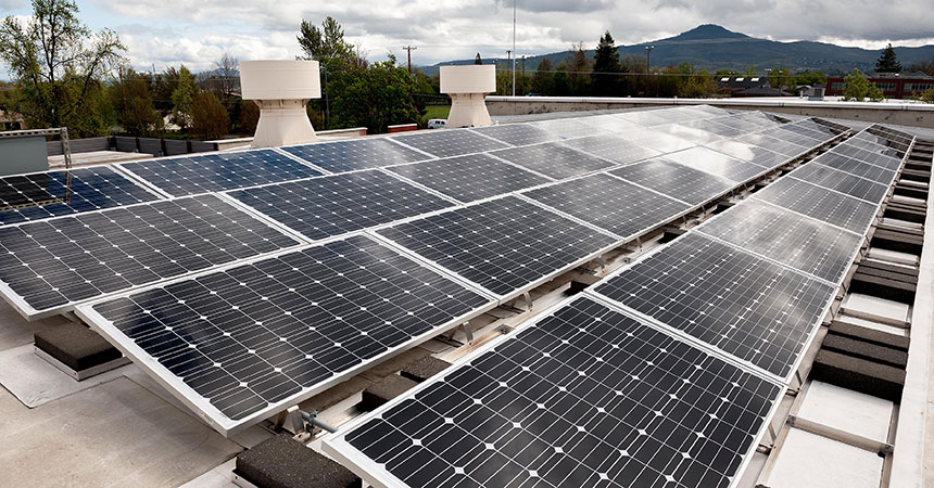 Rooftop solar panels with hill in background