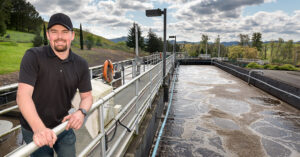 smiling man at a wastewater treatment plant