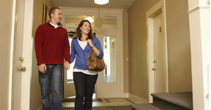 a couple walking in an apartment hallway