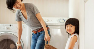 A mother and daughter washing their clothes