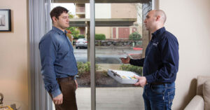 a man talking to an energy trust representative