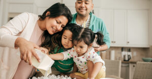 Family of four baking together