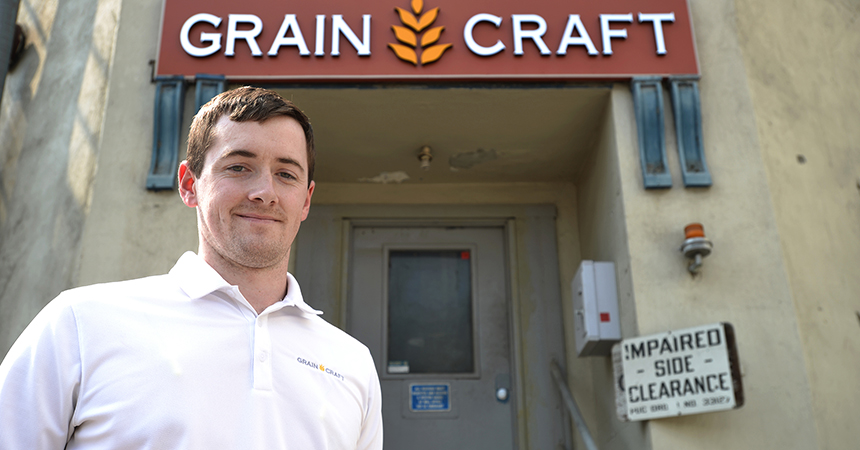 A man standing outside the Grain Craft building