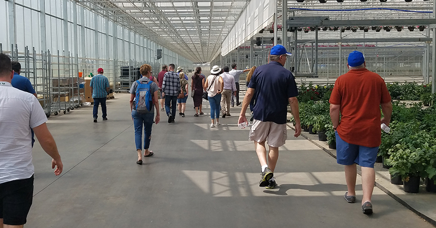 People walking though the green house at smith gardens