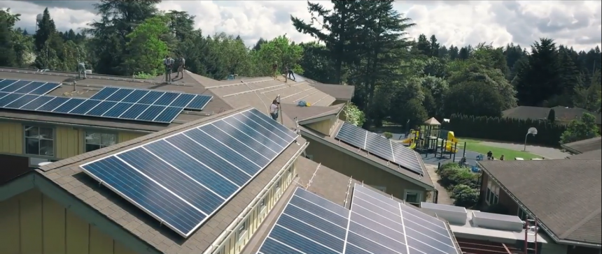 a collection of buildings with solar panels on their roofs