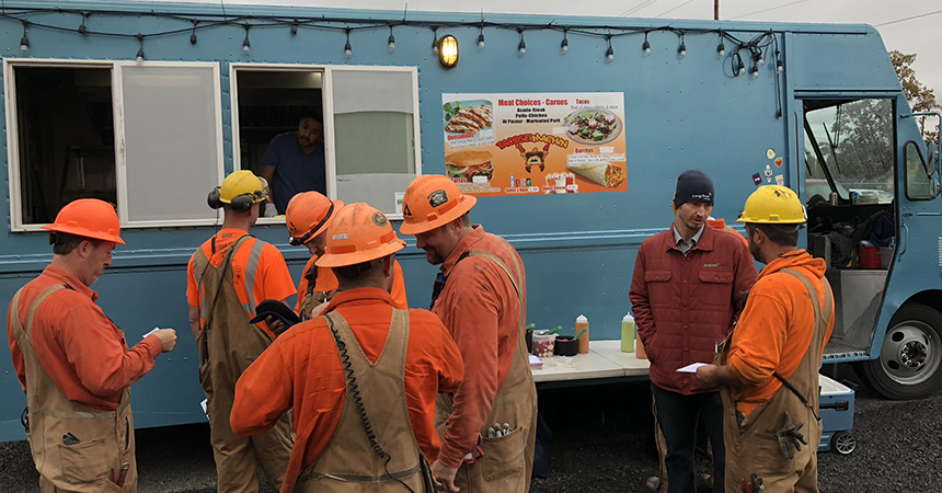 construction workers outside of a taco truck