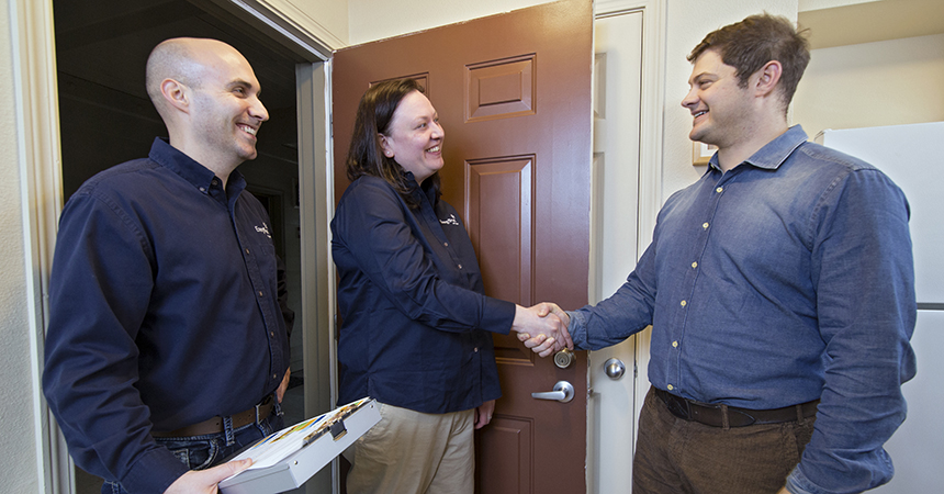 two trade ally representatives shaking hands with a resident