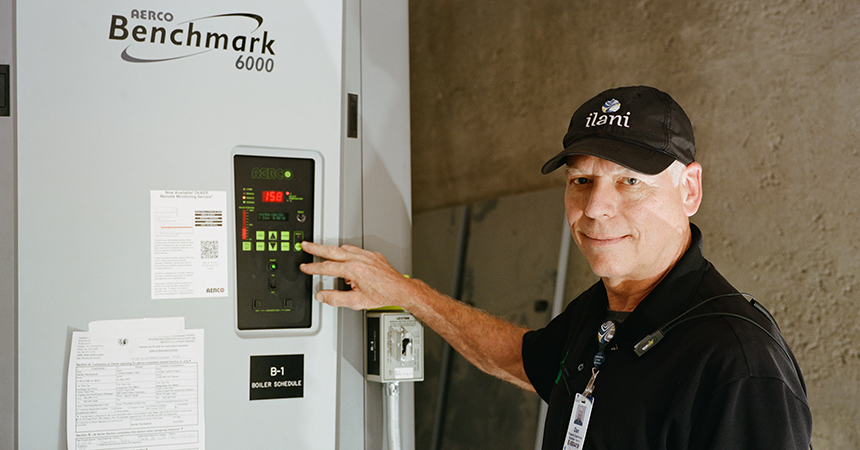 Dan Lincoln, building employee, ilani Casino Resort, demonstrates the control panel on a High-Efficiency Condensing Boiler.