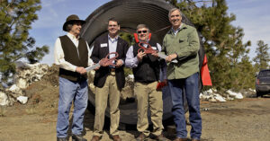 4 men smiling in front of a large irrigation pipeLeft to right: Ron Cochran, chair, Tumalo Irrigation District; Matthew Lohr, director, Natural Resources Conservation Service; Ken Rieck, manager, Tumalo Irrigation District; Jeff Merkley, United States Senator.