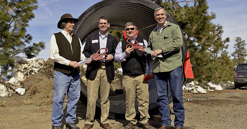 4 men smiling in front of a large irrigation pipeLeft to right: Ron Cochran, chair, Tumalo Irrigation District; Matthew Lohr, director, Natural Resources Conservation Service; Ken Rieck, manager, Tumalo Irrigation District; Jeff Merkley, United States Senator.