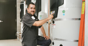 a technician inspecting an energy efficient water heater