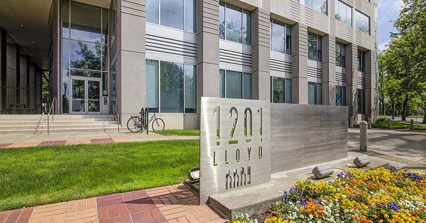 an image of the front of the Lloyd building, with flowers in the foreground