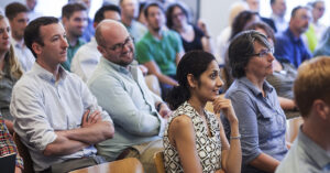 Attendees at a conference listening to a speaker.