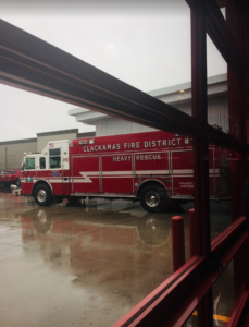 a firetruck in a rain covered lot outside a new building