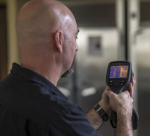 a man looking at a heat signal tool