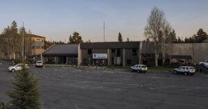 a parking lot and building at sunset