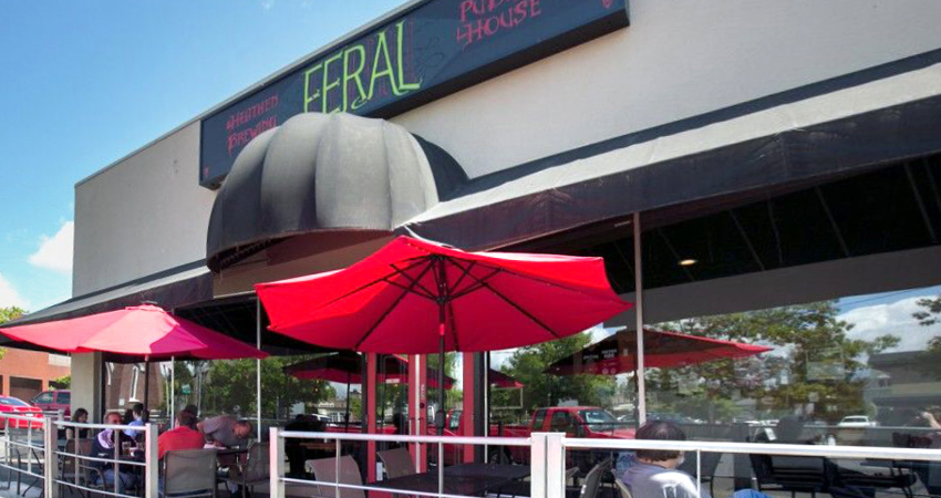 outdoor seating with red umbrellas providing shade